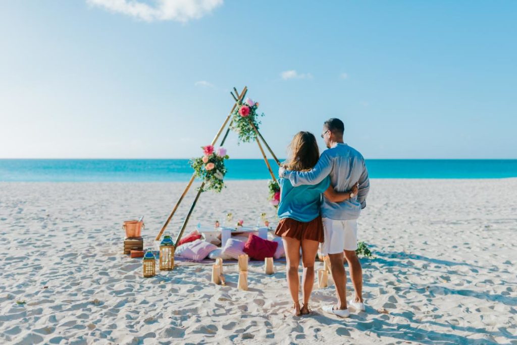 Couple having a Romantic Picnic on Eagle Beach