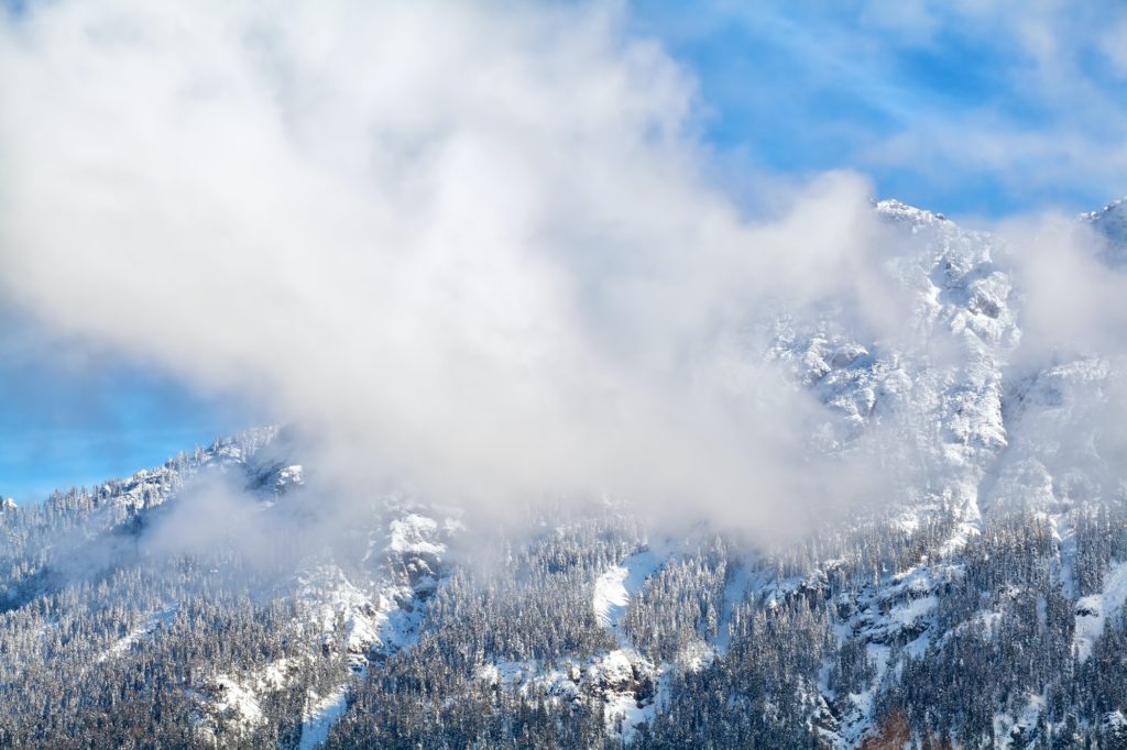 clouds over alpine winter peaks