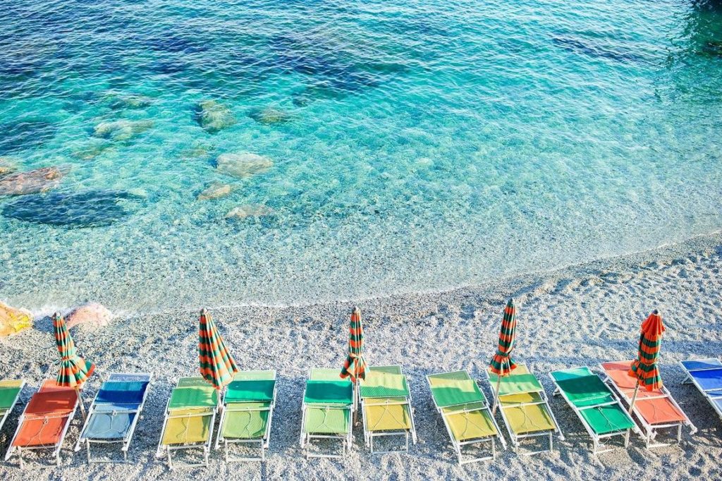 empty beach with closed umbrellas on italian coast XMWANR6 3d1b4654a6 1