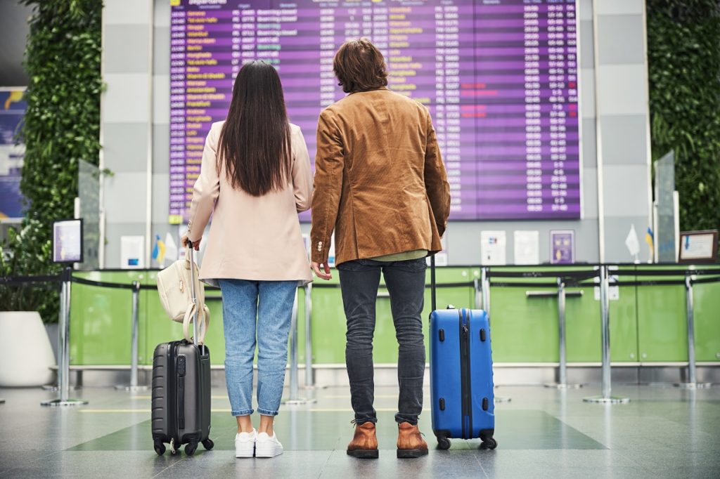 young couple travelers checking time of plane arri 2021 09 04 14 28 24 utc
