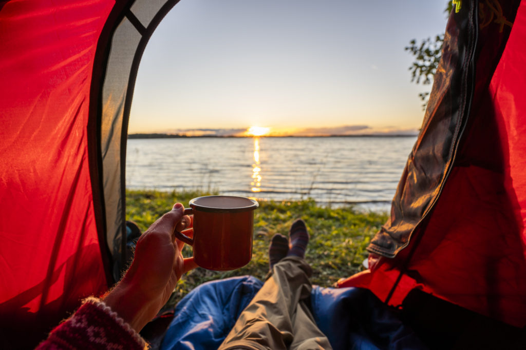 man camping in estonia watching sunset lying in t 2022 12 16 22 35 28 utc